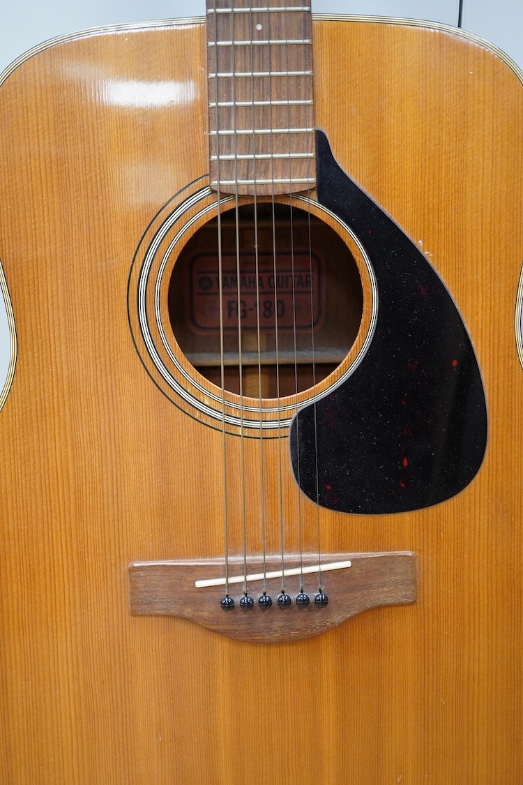 A Yamaha FG-180 acoustic steel string guitar